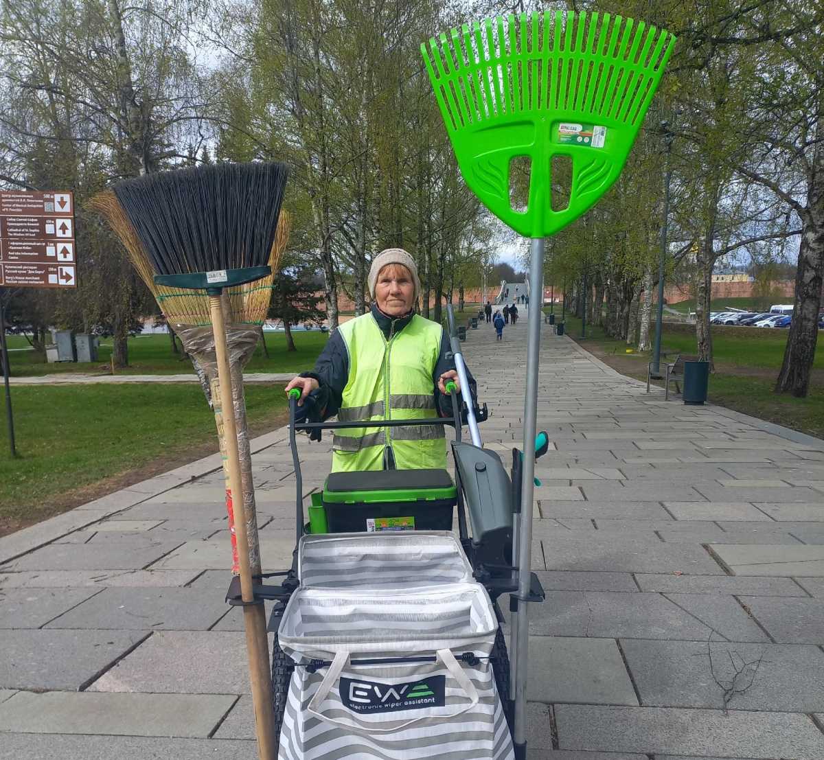 Один из самых опытных дворников Великого Новгорода проводит тест-драйв новой тележки для уборки